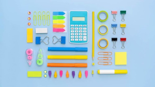 Top view colorful office stationery with calculator paper clips