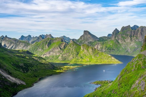 Mountain landscape with pointed mountain peaks and fjord Forsfjorden with village Vindstad