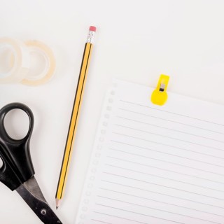 Close up single page pencil scissors cello tape white background