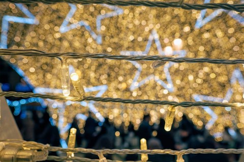 Christmas illumination LED lights garlands close up with stars in background