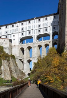 Pedestrian bridge over the Vltava with Mantle Bridge and Krumlov Castle