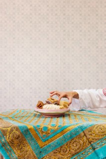 Hand taking piece arab pastry