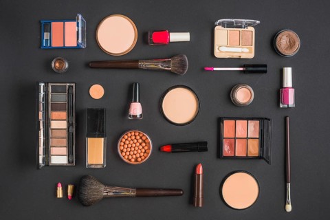 Different type makeup products black backdrop
