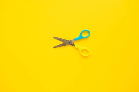 Opened scissors laid middle
