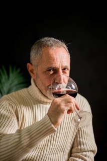 Senior man drinking red wine