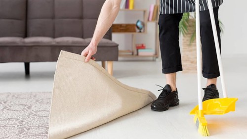Close up man brooming floor