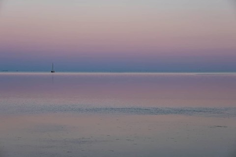 Ship in the Wadden Sea at sunset