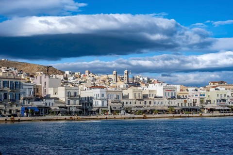 View of the town of Ermoupoli with pastel-coloured houses and the church of St Nicholas