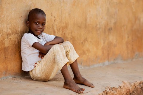 Full shot kid sitting outdoors