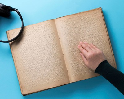 Braille book blue background flat lay