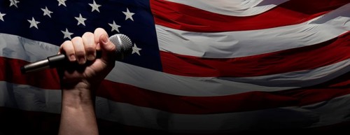 Male fist gripping microphone over waving american flag background banner