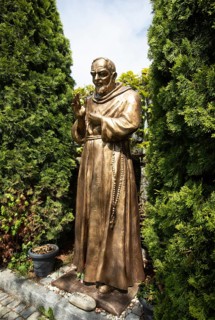 Statue of Padre Pio in front of the pilgrimage church Maria Himmelfahrt in Sammarei