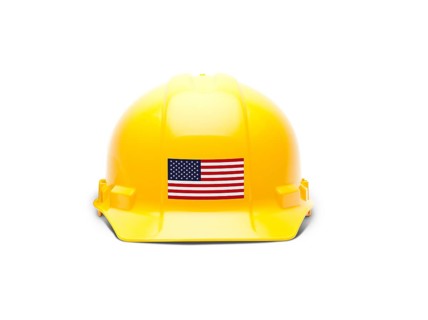 Yellow hardhat with an american flag decal on the front isolated on white background