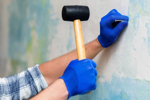 Front view hands holding hammer