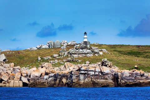Coastline with granite rocks and Peninnis Lighthouse