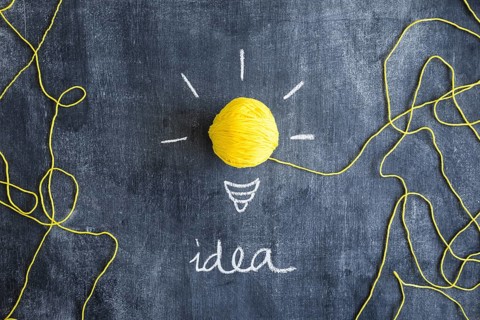 Idea text with yellow ball wool as light bulb chalkboard