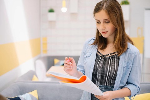 Concentrated girl posing with textbook