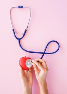 Top view hands checking heart with stethoscope