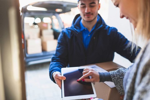 Woman giving online signature deliveryman