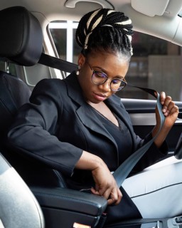 Side view woman putting seat belt drive