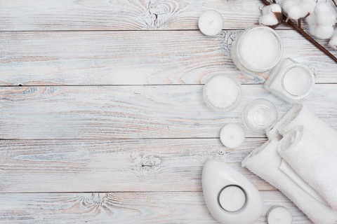 Bath salts cotton flowers wooden background