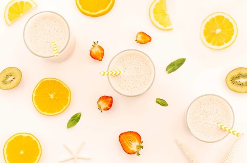 Milkshakes with straws cut fruits berries