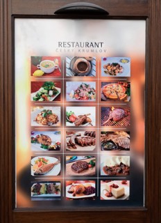 Menu in front of a restaurant in the historic old town of Krumlov