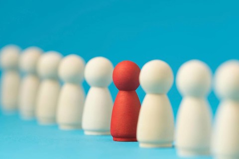 Focused red pawn surrounded by white ones