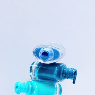 Close up blue shades nail polish with stacked open bottle