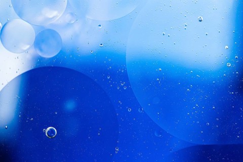 Faded oil drops water surface abstract background