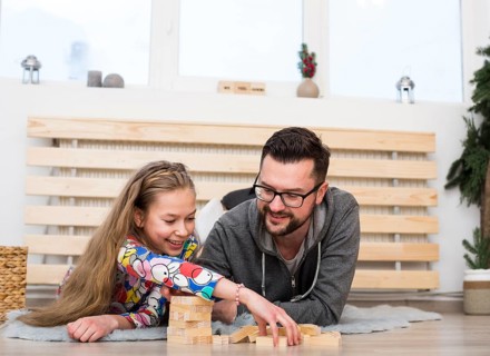 Father daughter playing with wood blocks