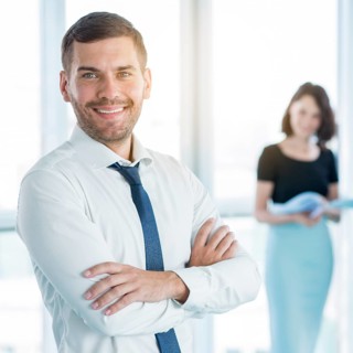 Portrait happy businessman with folded arms