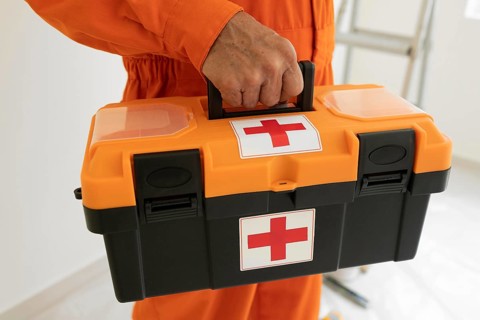 Portrait man with safety protection equipment first aid kit