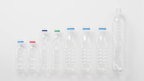 Various types plastic bottles grey background