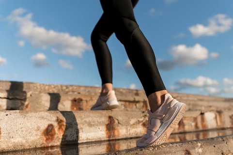 Woman jogging stairs close up