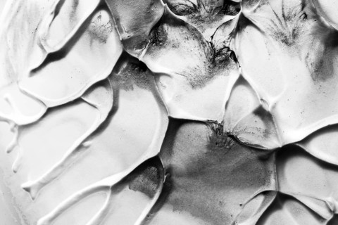 Close up old black white cracked textured wall