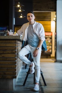 Modern young man with glass whiskey bar counter