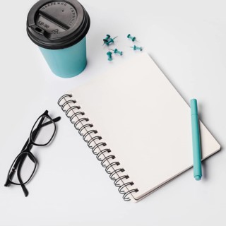 Disposable coffee cup pen eyeglasses spiral notepad thumbtack pins white background