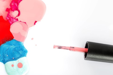 High angle view multi colored nail polish brush white background