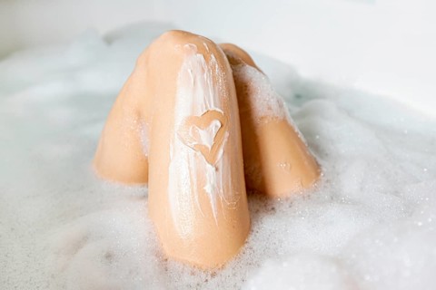 Close up legs bathtub with foam