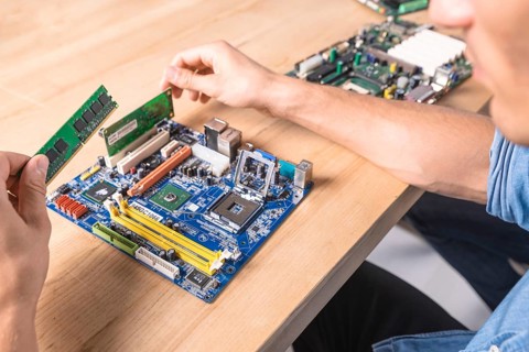 Engineer putting ram memory module motherboard