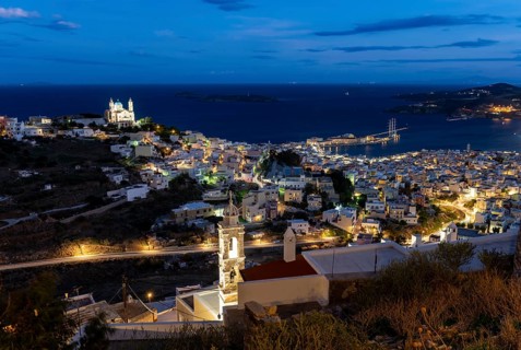 View of the illuminated town of Ermoupoli with Anastasi Church or Church of the Resurrection