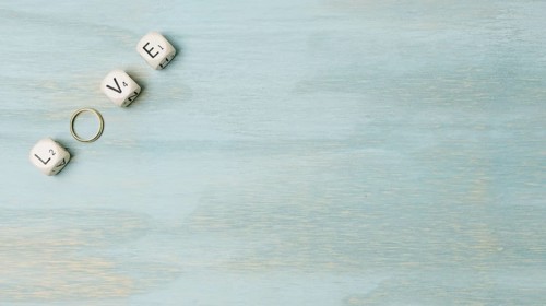 Overhead view text made with cubes wedding ring corner wooden backdrop