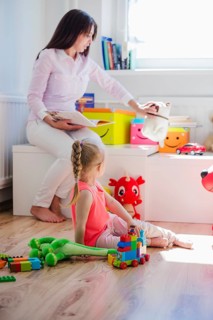Woman playing with child playroom