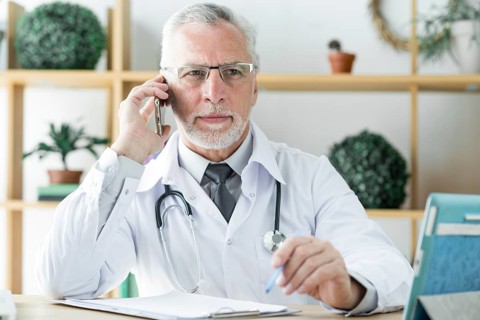 Doctor speaking phone looking away