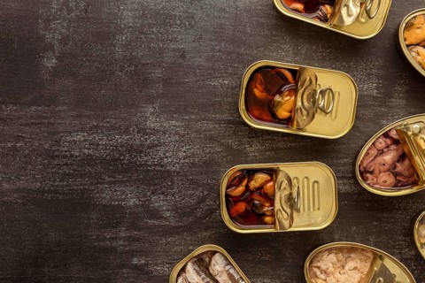 Top view preserved food cans with copy space