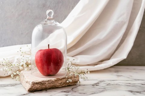 Jar with apple flowers beside