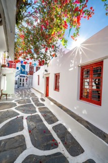 Cycladic Greek Orthodox Church with red bougainvillea