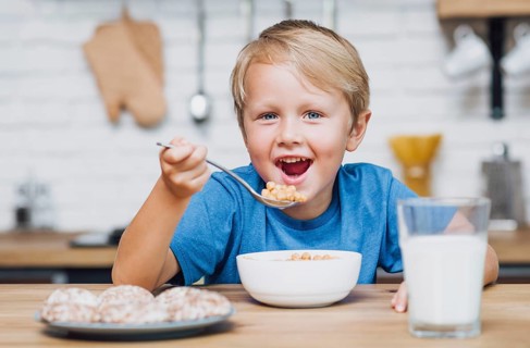 Smiley kid eating cereal