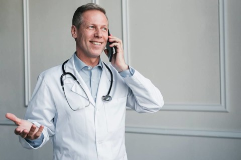Doctor making phone call